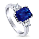Rhodium Plated Sterling Silver Simulated Blue Sapphire Emerald Cut Cubic Zirconia CZ 3-Stone Anniversary Promise Engagement Ring